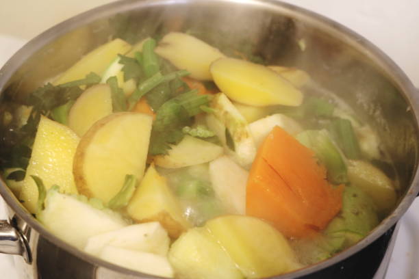 istock Steaming Vegetable Broth with Potatoes, Pumpkin, and Greens 2186988306