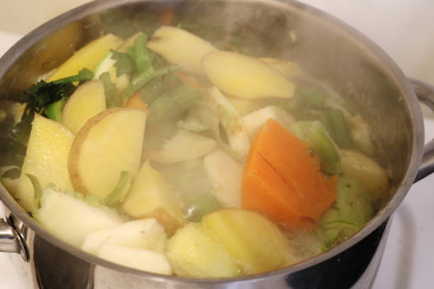 istock Steaming Vegetable Broth with Potatoes, Pumpkin, and Greens 2186988313