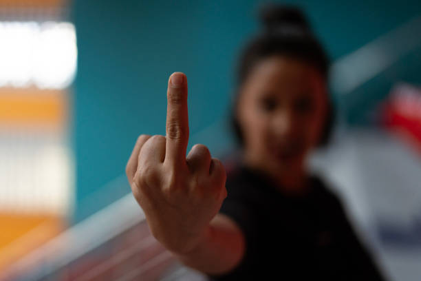 istock Young woman showing middle finger in blurred background 2186988554