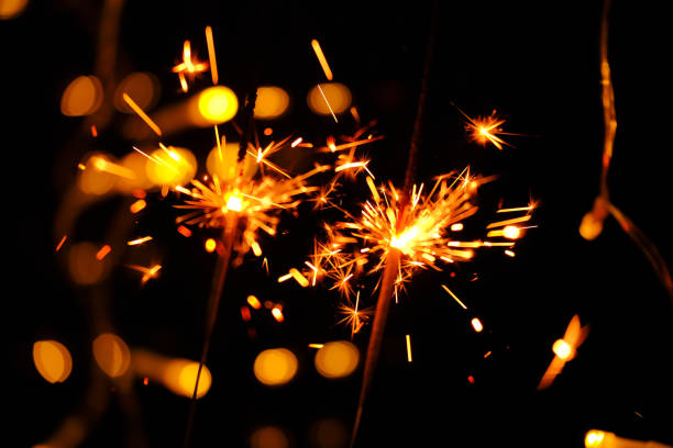 istock Sparkling shining fireworks with gold glitter and bokeh on black background.Sparkler Fireworks with Bokeh Effect.Close-Up of Sparklers Against Dark Background.Sparklers with Bokeh Lights at Night 2186989785