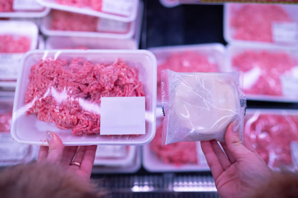 istock Woman's hands holding dumpling wrappers and minced meat 2186989974