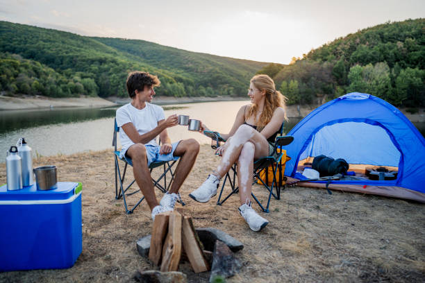 istock Friends relax and have fun while camping by the lakeside 2186992231