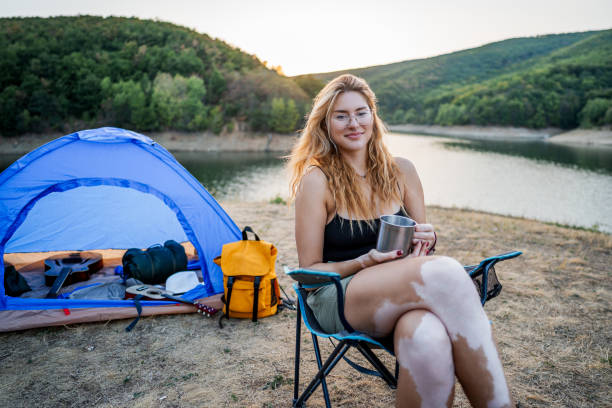 istock Woman during camping by the lake 2186992419