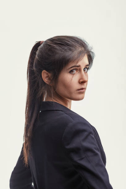 istock Businesswoman looking over shoulder with apprehensive expression 2186992448