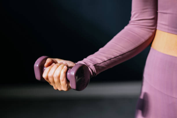 Woman Holding Dumbbells During Indoor Workout Session