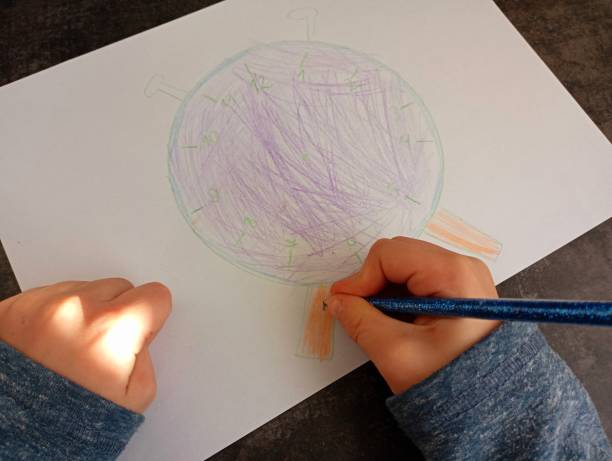 istock Drawing of a clock by a child. A little boy is doing his drawing homework. 2186993573
