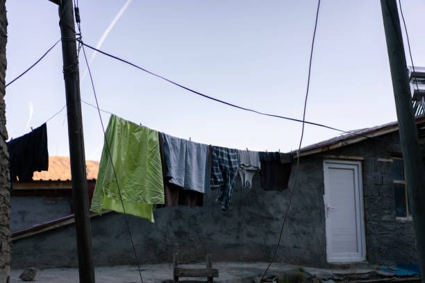 istock Laundry hanging on clothesline in rural courtyard 2186995628