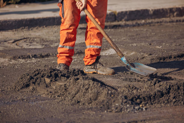 istock Construction workers working on a new asphalt layer on a public street. 2186997908