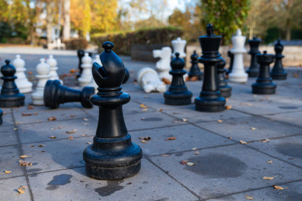istock Outdoor chess game with large pieces in a park setting during autumn 2186999777