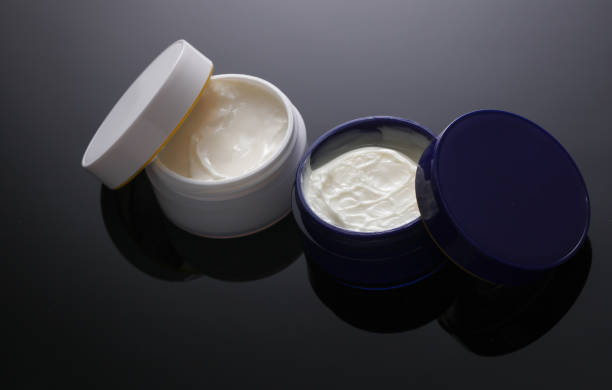 istock Night and day open cream jars on black background. 2187000311