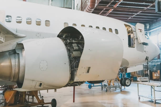 istock White passenger jet plane in the airplane hangar. Airliner under maintenance 2187001347