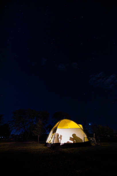 istock Young children reading books in a tent visible by their shadows 2187001870