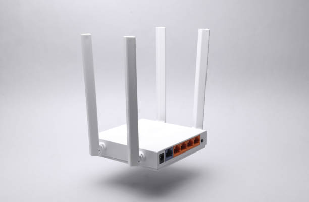 istock Modern four-antenna Wi-Fi router with sockets floating on gray background 2187001902