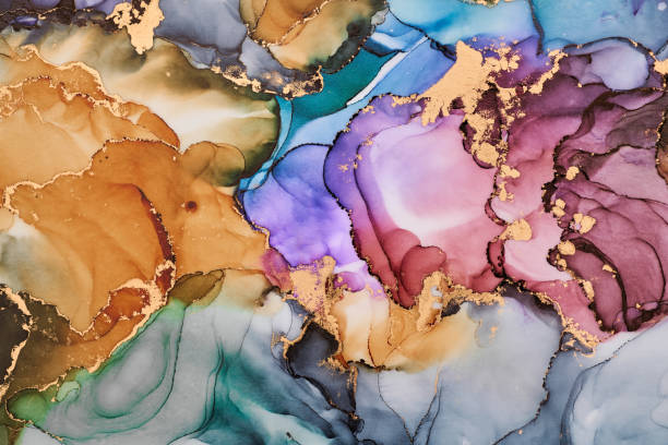 istock Current of translucent hues intertwine with metallic gold veins, shaping organic luxurious landscape. This fluid art, abstract liquid ink technique, light and shadow dance across free-flowing textures 2187001904