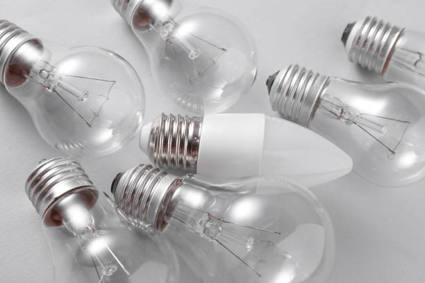 istock LED and ncandescent light bulbs on gray background. Energy saving 2187001935