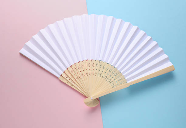 istock Traditional white Asian hand fan on pink blue background 2187001974