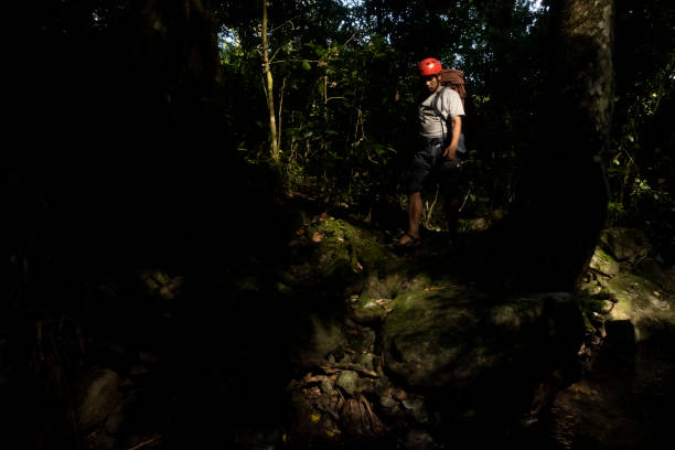 istock a man with a backpack walking in the forest-Stock Photo 2187002409