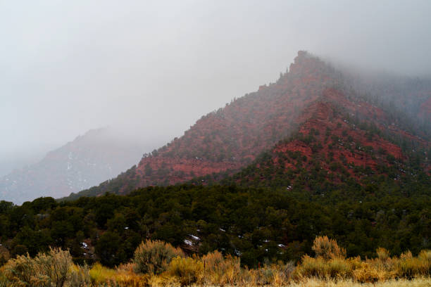 Dramatic Mysterious Red Rock Canyon Landscape During Winter Storm - Beginning of winter storm as clouds roll in and create drama and mystery.