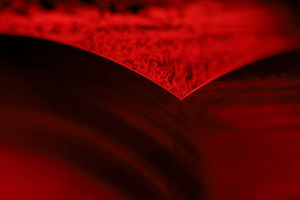 istock Red reflections of liquid in macro, dark liquid panels 2187005160