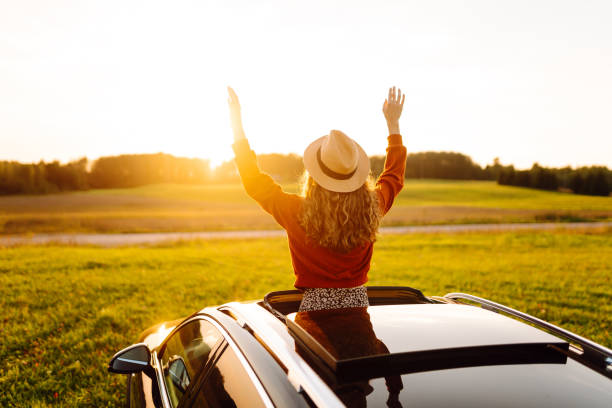istock Relaxed  woman enjoys sunset views from the car window. 2187007809