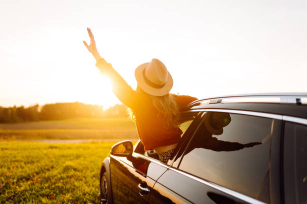 istock Relaxed  woman enjoys sunset views from the car window. 2187007823