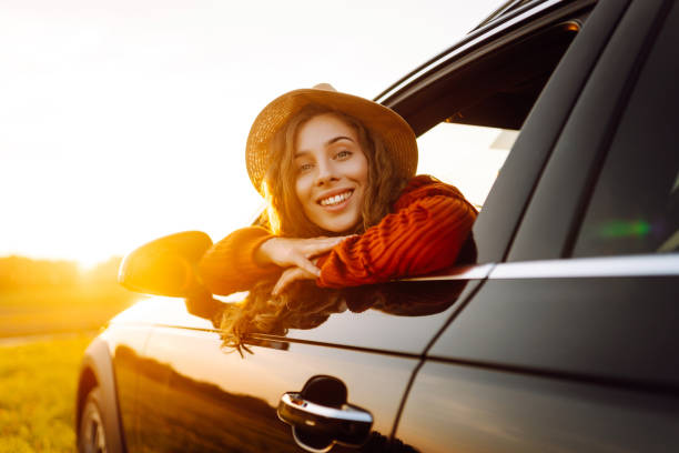 istock Relaxed  woman enjoys sunset views from the car window. 2187007843