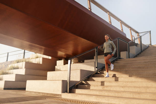 istock A morning runner is seen energetically navigating urban stairs which lie beneath a bridge 2187009789