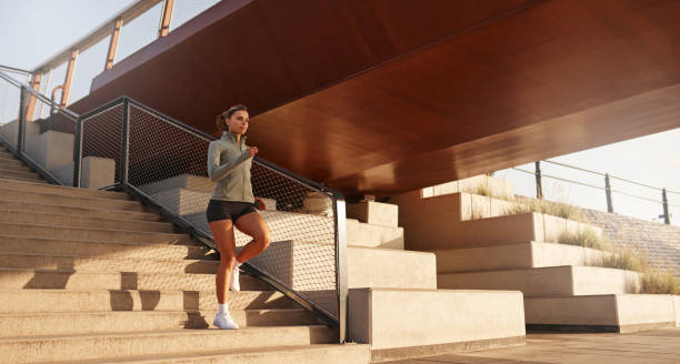istock A morning runner is seen energetically navigating urban stairs which lie beneath a bridge 2187009794