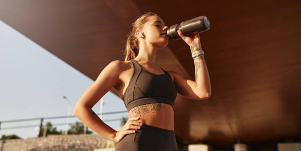 istock A Fit and Young Woman is Enjoying a Refreshing Beverage While Outdoors in Nature 2187009816