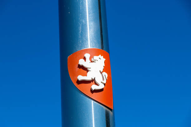 Saragossa, Saragossa - Spain - 09-10-2021: Coat of arms with a white lion on a red shield, mounted on a polished silver post, against a clear blue sky with visible details.