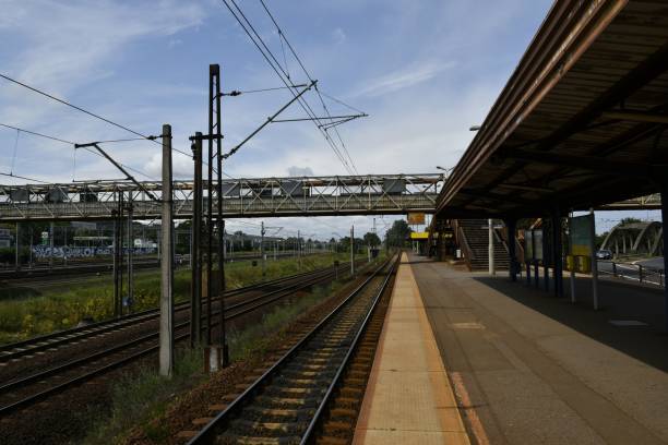 istock Empty railway under a clear sky with a bridge in the background 2187010873