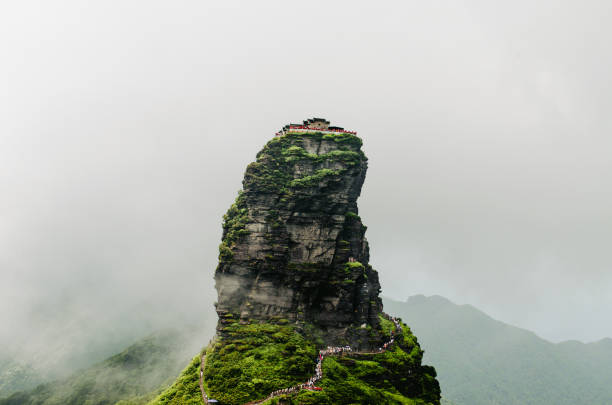 Fanjin Shan, a sacred Buddhist mountain in Guizhou, China, is famed for its striking rock formations, verdant forests, and the Golden Summit Temple perched atop a precarious cliff. This UNESCO World Heritage Site offers breathtaking views and spiritual tranquility.