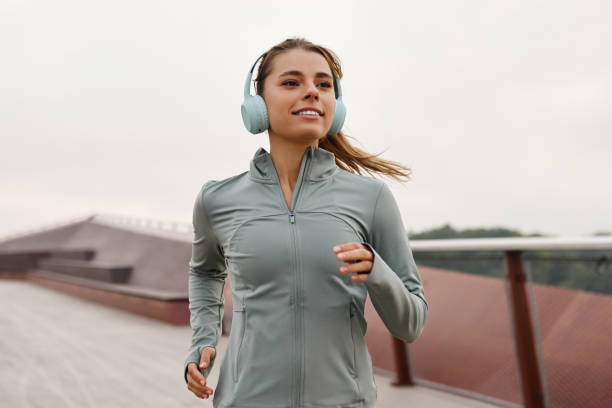 istock An Energetic Young Woman Jogging Outdoors While Wearing Comfortable Athletic Apparel 2187013091