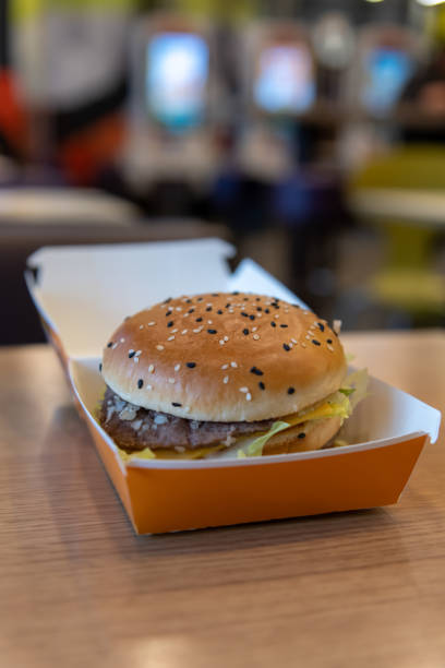 istock cheeseburger in cardboard box on wooden table 2187014544