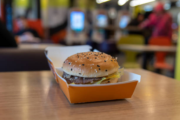 istock cheeseburger in cardboard box on wooden table 2187014751