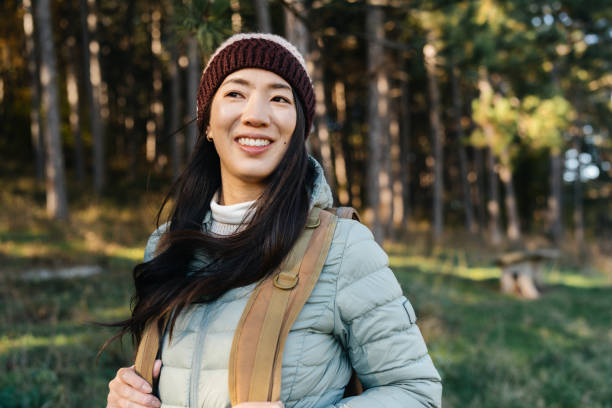 istock Japanese woman carrying a backpack taking a hike in nature 2187015759