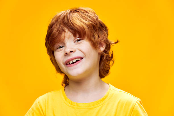 istock Cute red-haired boy smile close-up yellow 2187016234