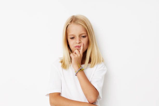 Little cute girl with blond hair posing studio. High quality photo