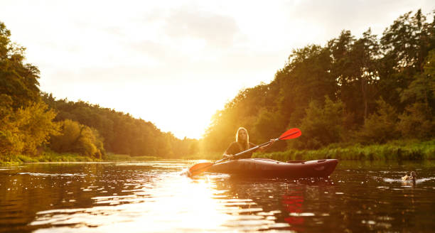istock Experience a Serene and Beautiful Kayaking Adventure during Sunset on a Calm River Escapade 2187018027