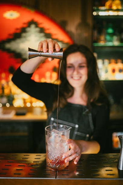 istock Young female bartender pouring cocktails in a cocktail bar 2187018272