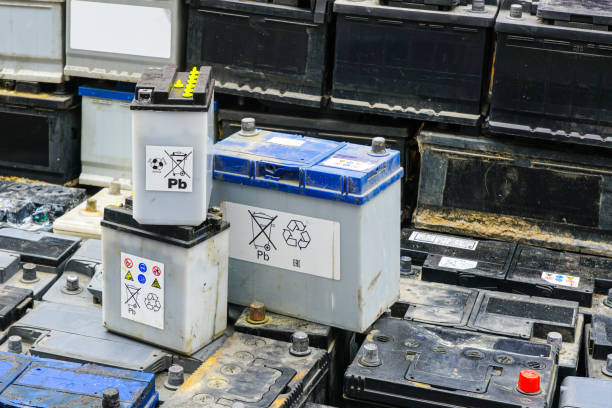 istock Stack of many used car batteries for recycling in a hazardous waste facility 2187018576