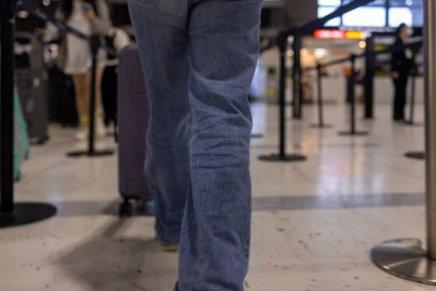 istock Traveler Walking Through Airport Queue with Suitcase 2187019850