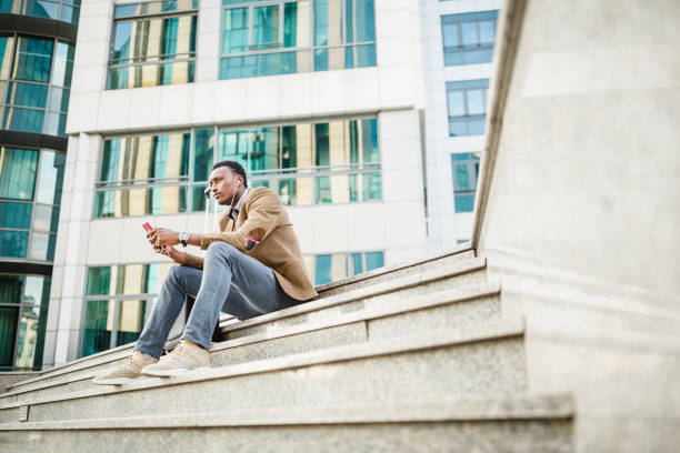 istock Young Professional Using Smartphone on City Steps 2187019920