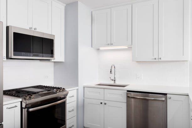 istock A white kitchen with stainless steel appliances. 2187021614