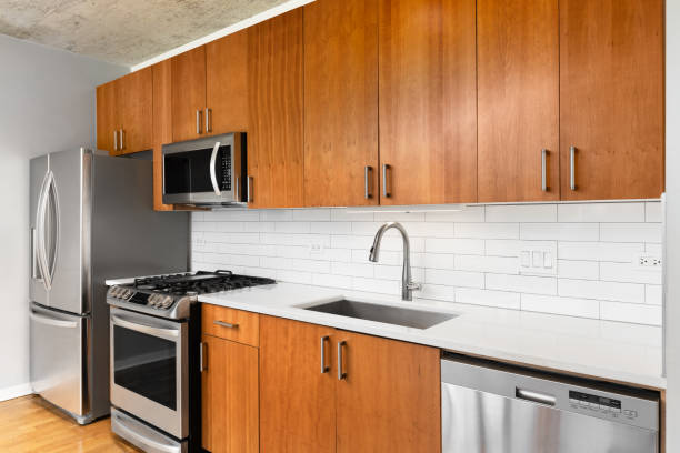 istock A kitchen detail with wood cabinets and a white subway tile backsplash. 2187021630
