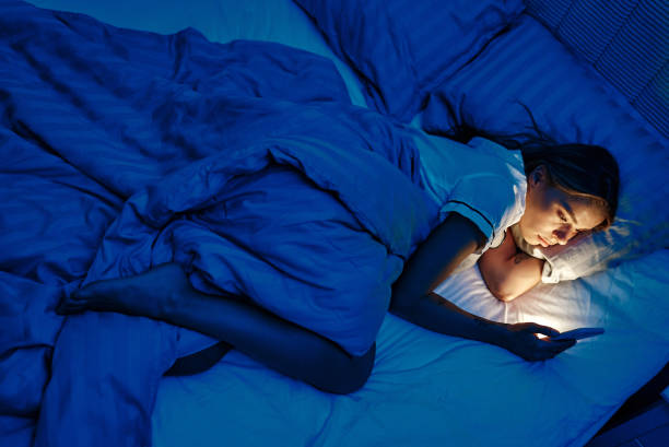 istock A young woman is using her smartphone while relaxing in bed during the night hours 2187022844