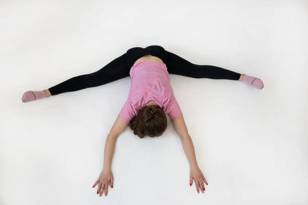 woman doing pilates workout at studio shot, gray background. Sport concept