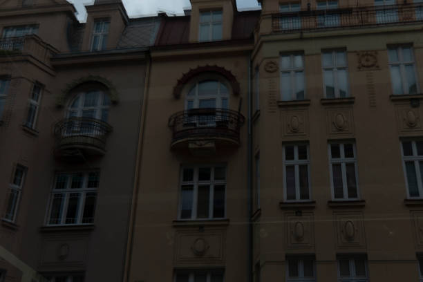 The facade of a preserved historic building showcases intricate balconies and elegant windows