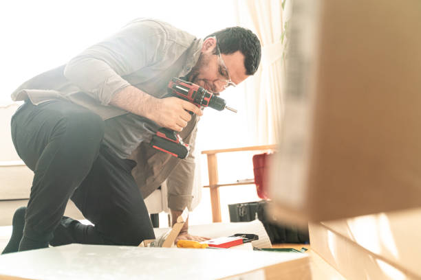 istock Man in a new home who assembles furniture for self-assembly 2187023683