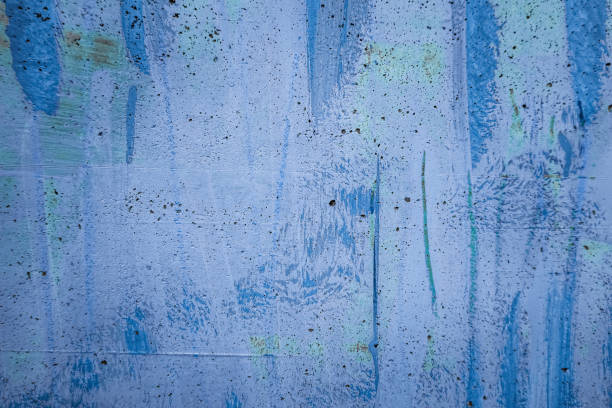 istock Messy paint strokes and smudges on grunge purple painted wall background. Creative modern urban city background with blue, purple, white color drips, flows, streaks of paint and paint sprays 2187028186